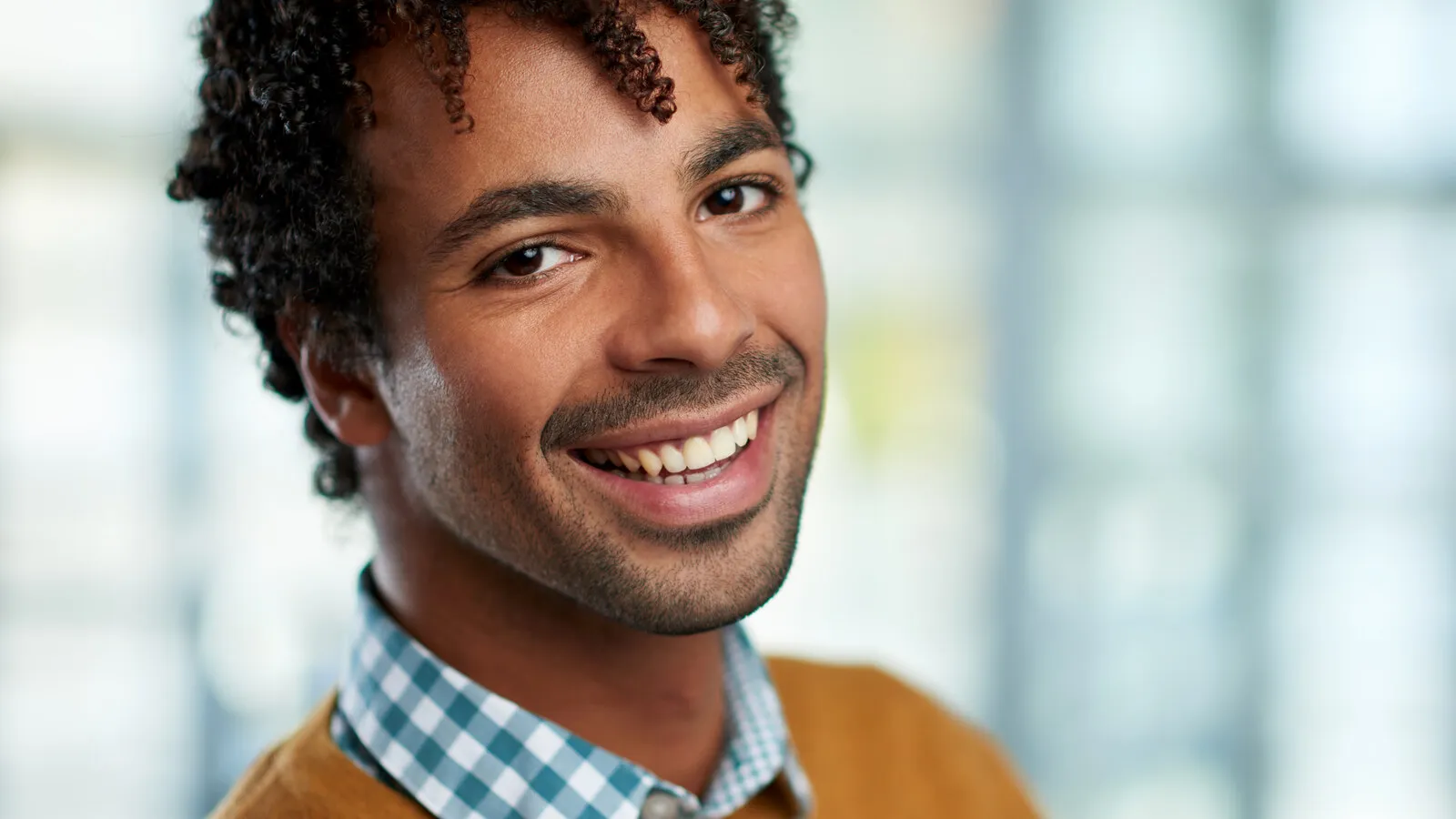 A close horizontal headshot of a person in soft natural light, calm and present.