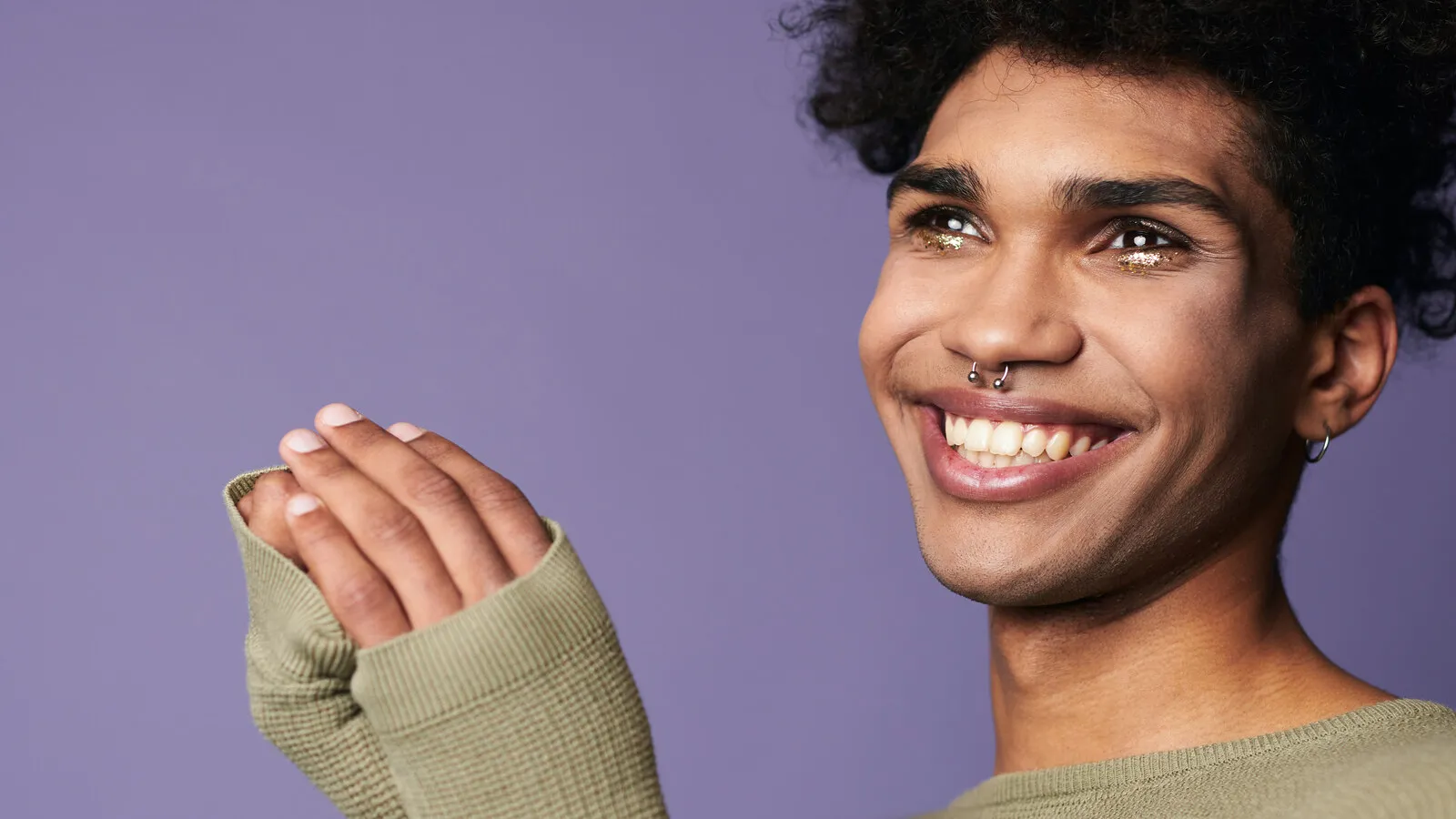 A young person looking calmly off-camera in soft afternoon light, expression peaceful and unguarded.